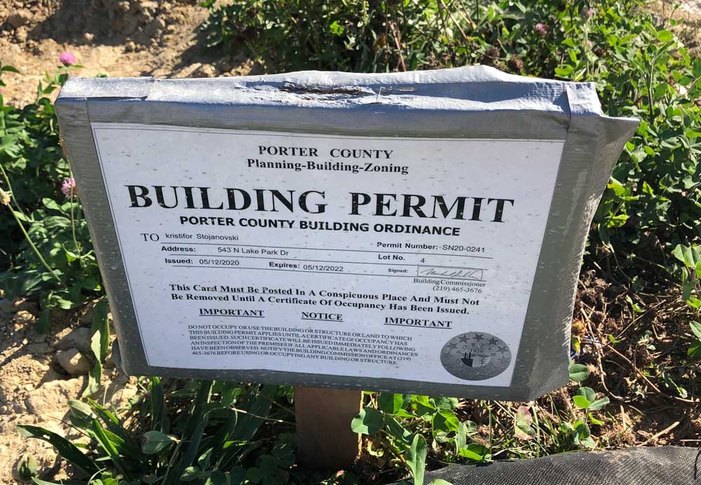 Photo of a building permit posted in front of a construction project